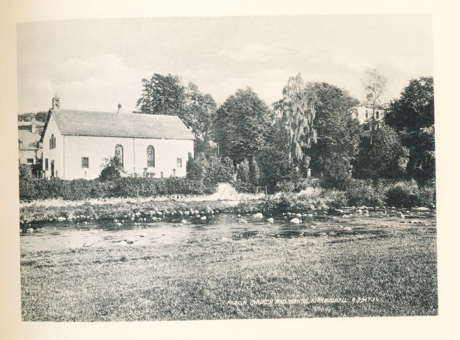 The church is on the left and the manse is on the hill between the trees on the right.