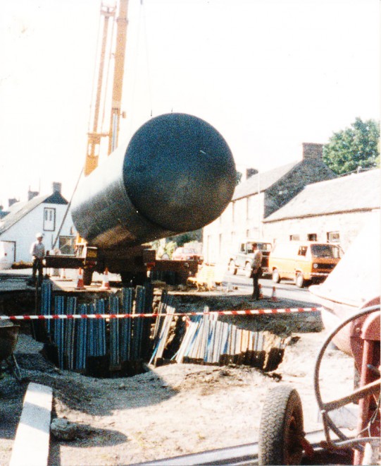 Installing a new petrol tank at the garage forecourt, Kirkmichael Main Street, c. 1990.