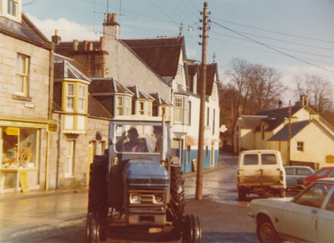 A tractor pulls into the garage, Kirkmichael, c. 1980.