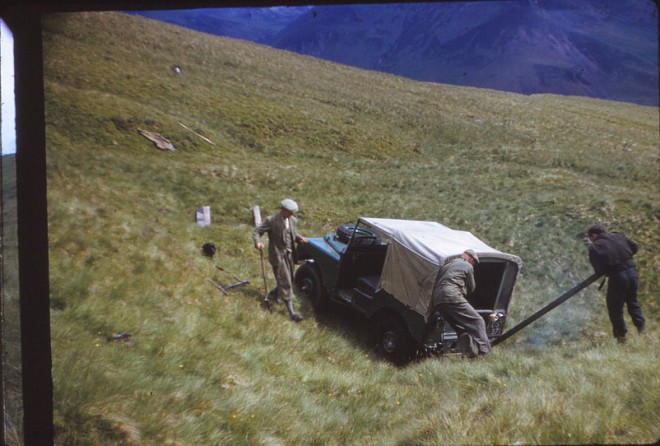 Trying to get a vehicle unstuck. Jim Ramsay is pushing.