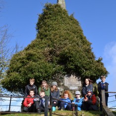 The children at the memorial, which is now overgrown with ivy (compare with black & white photo of memorial  from c. 1920). There is also not much room for parties to pay their respects.